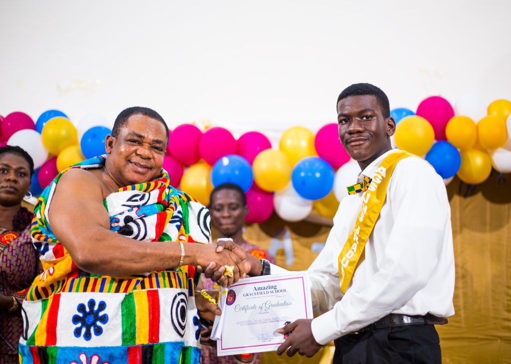 PTA Chairman presenting a certificate to a graduate